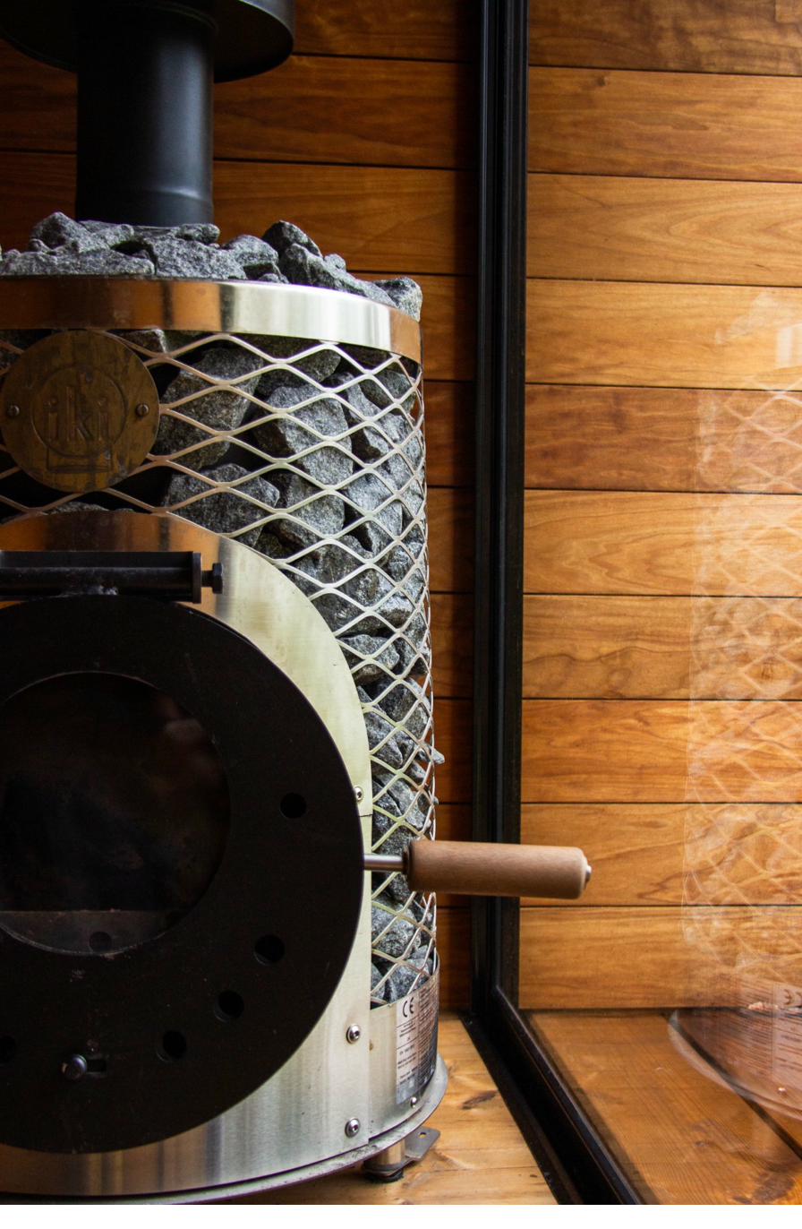 IKI branded sauna heater with mesh stone basket and Finnish granite stones