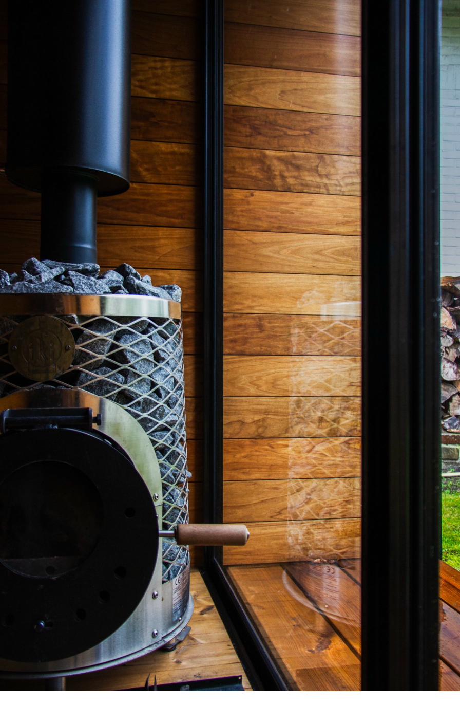 Premium glass door detail of the IKI wood-burning sauna stove