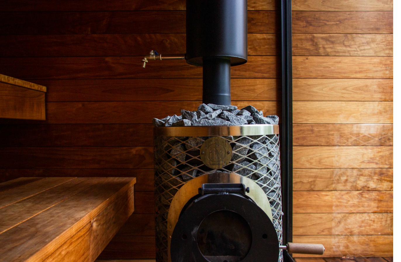 IKI wood-burning stove with Finnish granite sauna stones, the heart of a Finnish sauna
