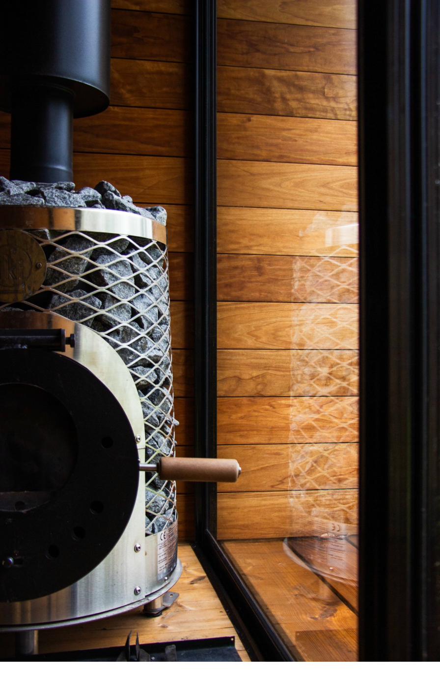 Interior detail of the IKI wood-burning stove inside the iHKA outdoor sauna